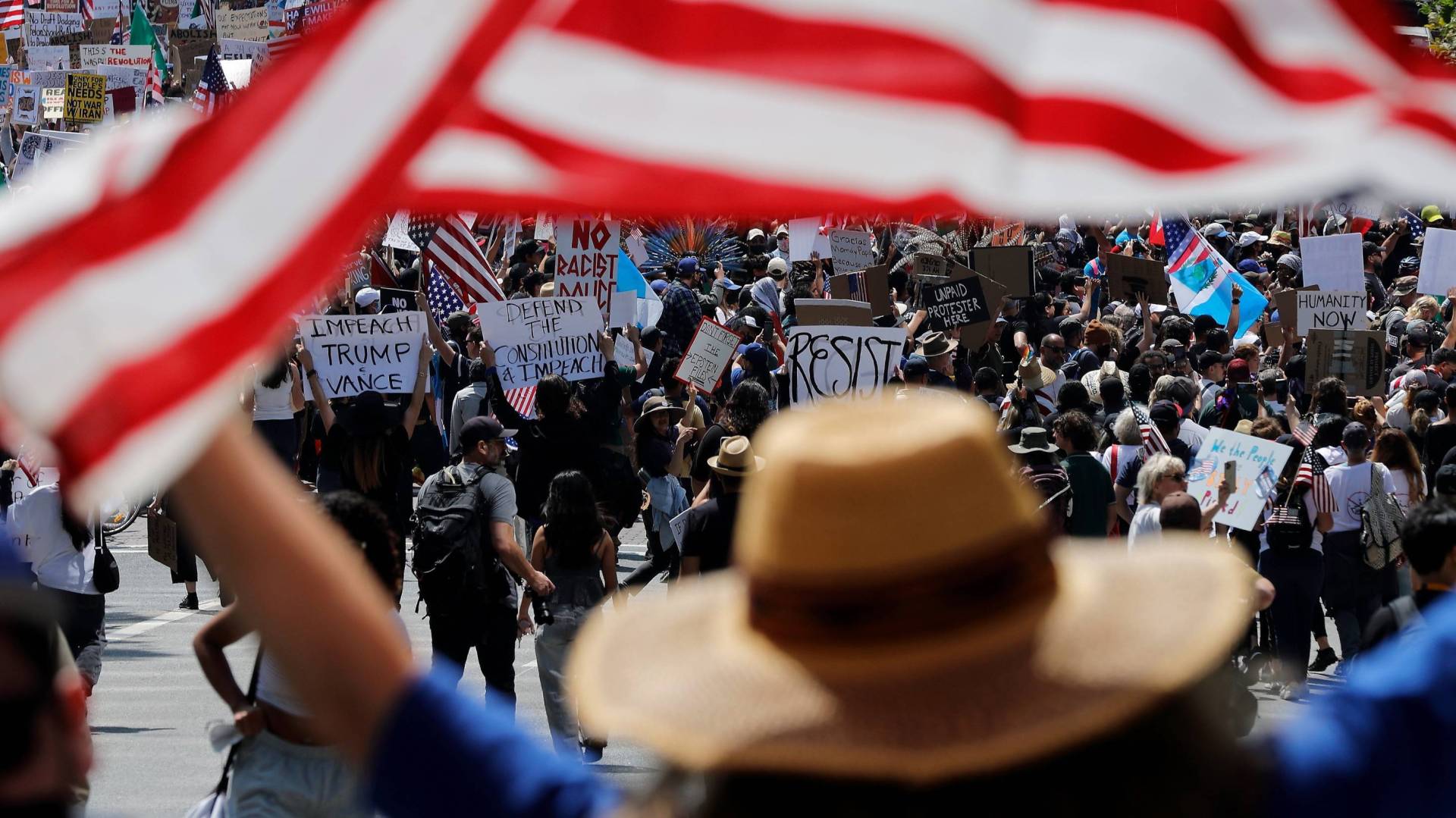No Kings protester holds American flag