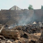 Smoke rises from a burned house following an attack on a Nigerian farming community on June 13, 2025.