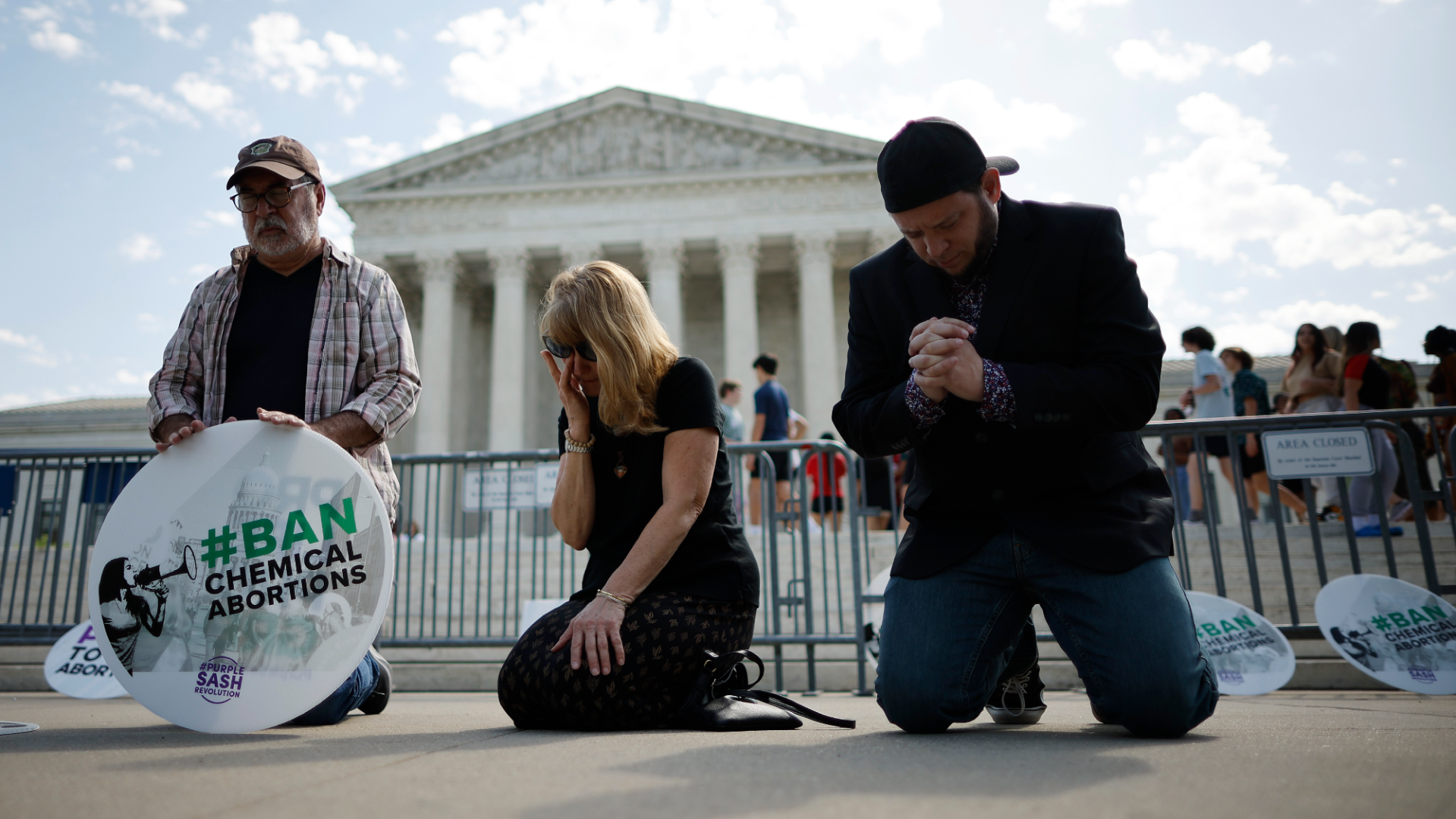 Protestors pray in front of the Supreme Court.