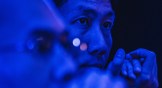 A photo of a tech engineer with blue lighting
