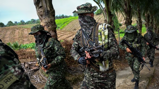 Members of a FARC dissident guerrilla group march on a rural area of Colombia.
