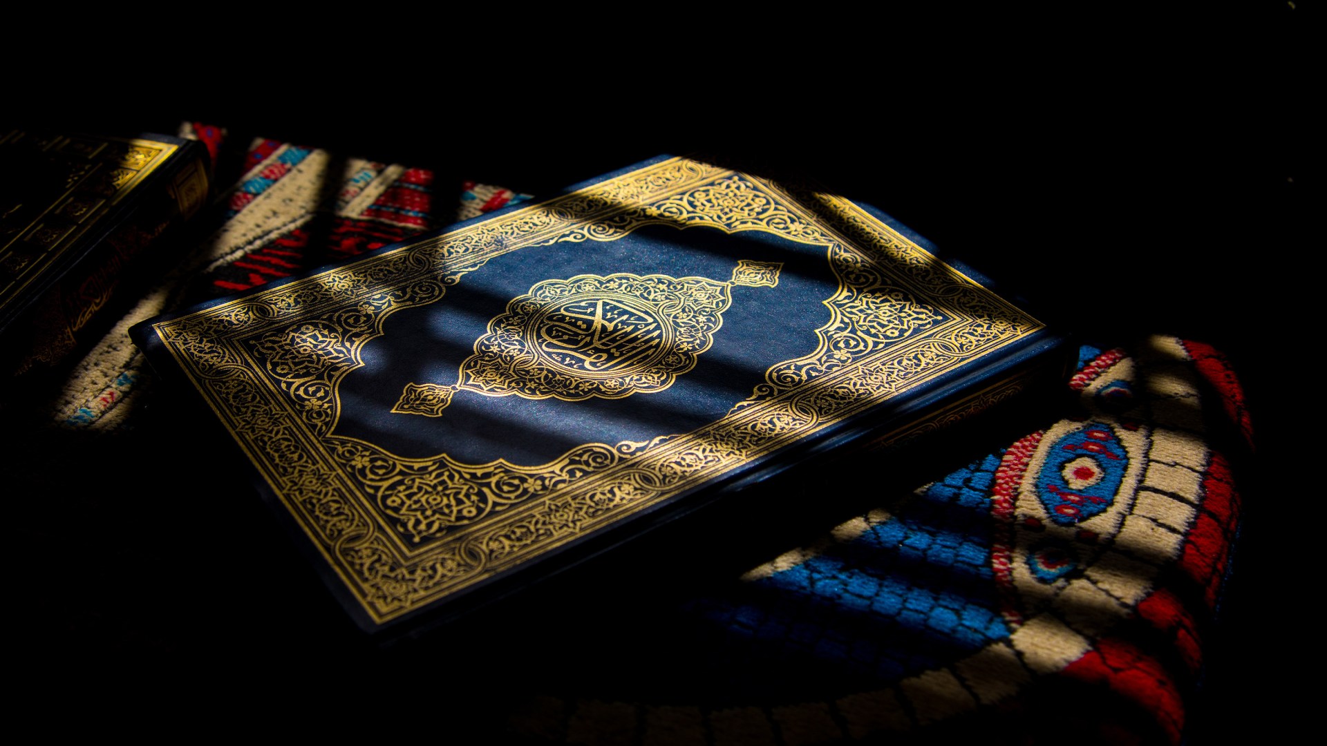 The Quran with a beam of light resting on it.
