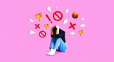 A person shielding her head from angry emojis.