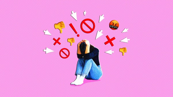 A person shielding her head from angry emojis.