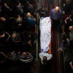 Christian Palestinian mourners attend the funeral ceremony of victims killed in an Israeli strike that hit the Holy Family Church in Gaza.