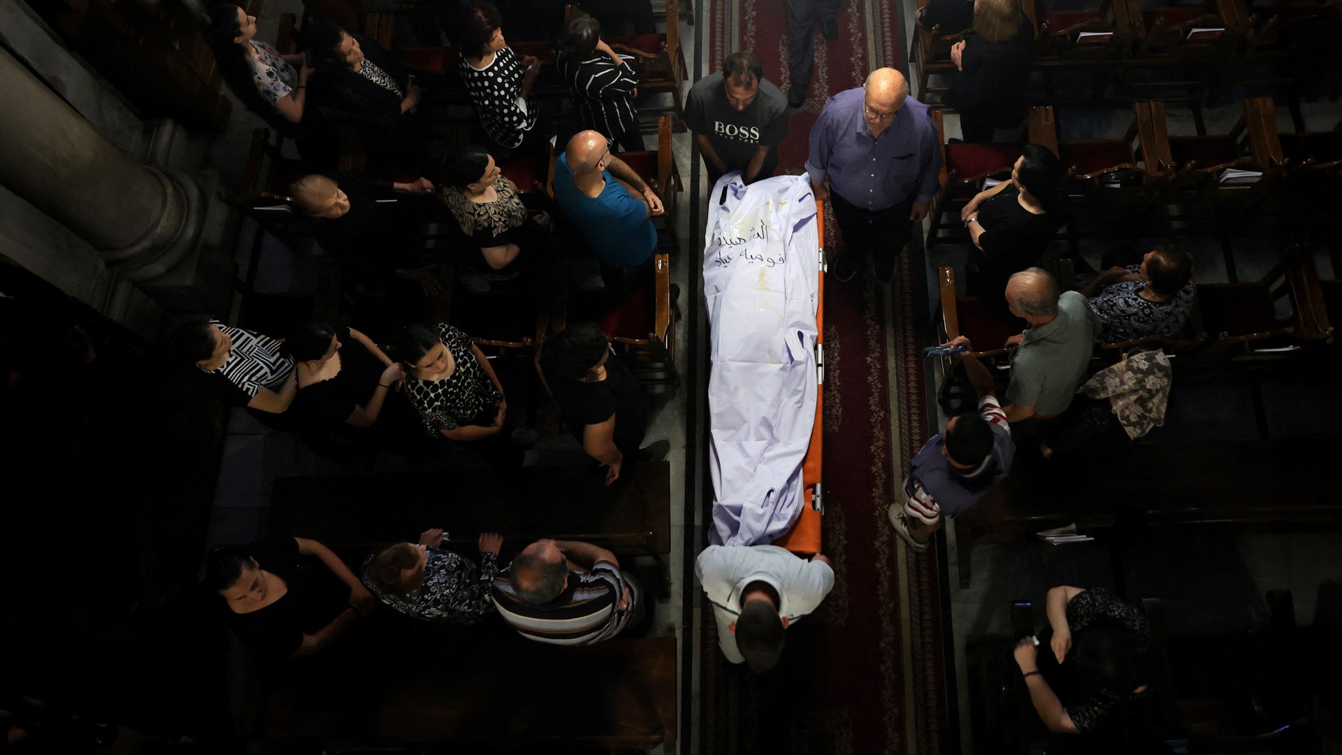 Christian Palestinian mourners attend the funeral ceremony of victims killed in an Israeli strike that hit the Holy Family Church in Gaza.