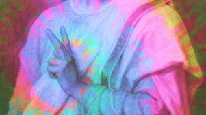 Jesus making a 'peace' sign with his fingers.