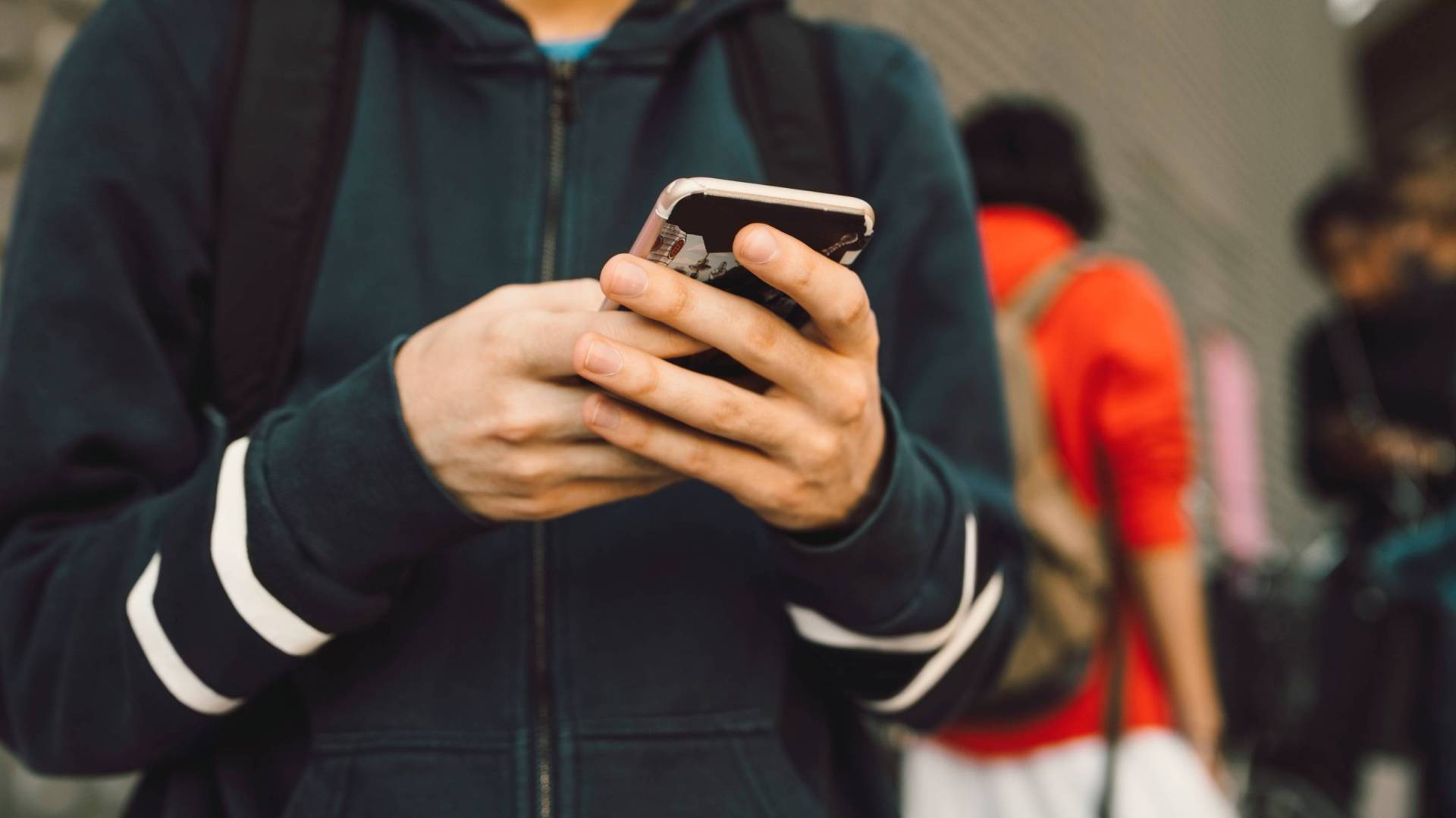 Child looks at smartphone