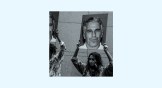 A protest group holds up signs of Jeffrey Epstein