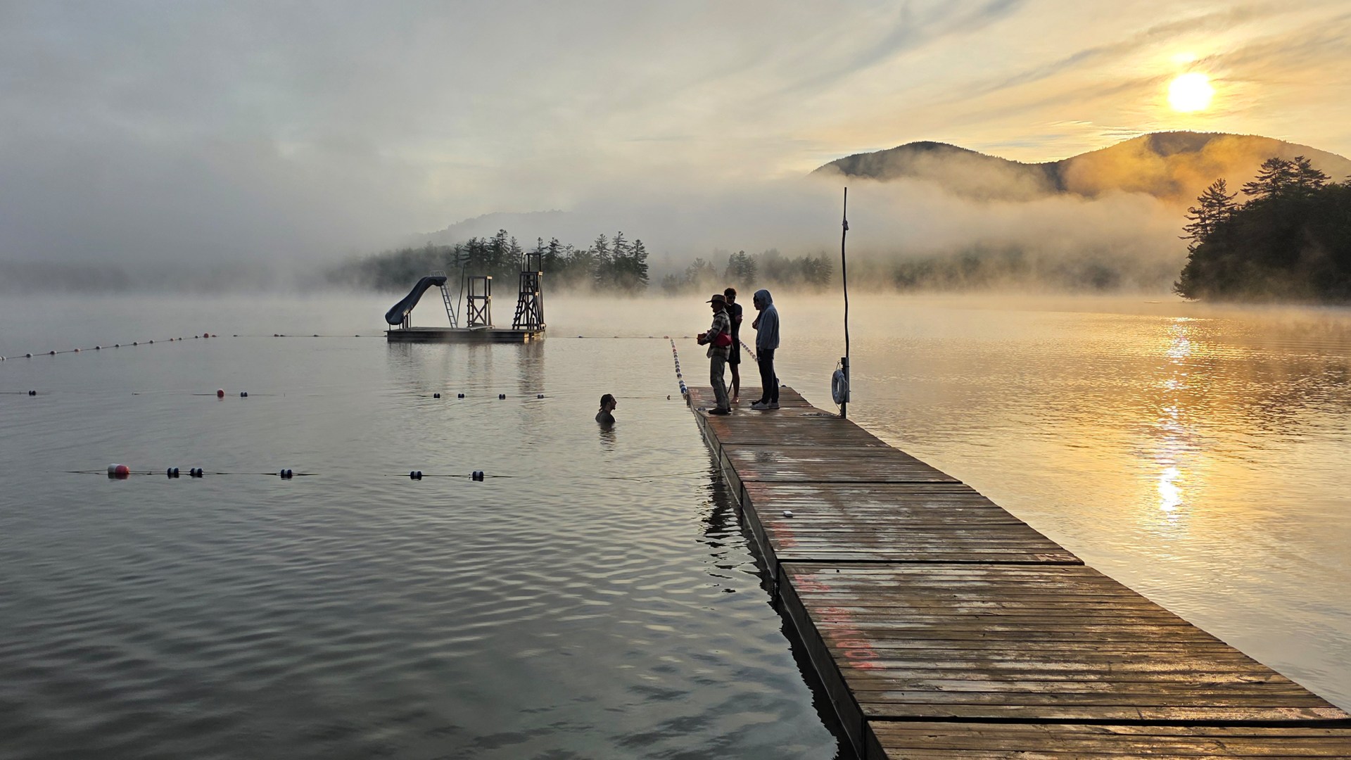 Campers stand on the pier at the Christian summer camp, Deerfoot.