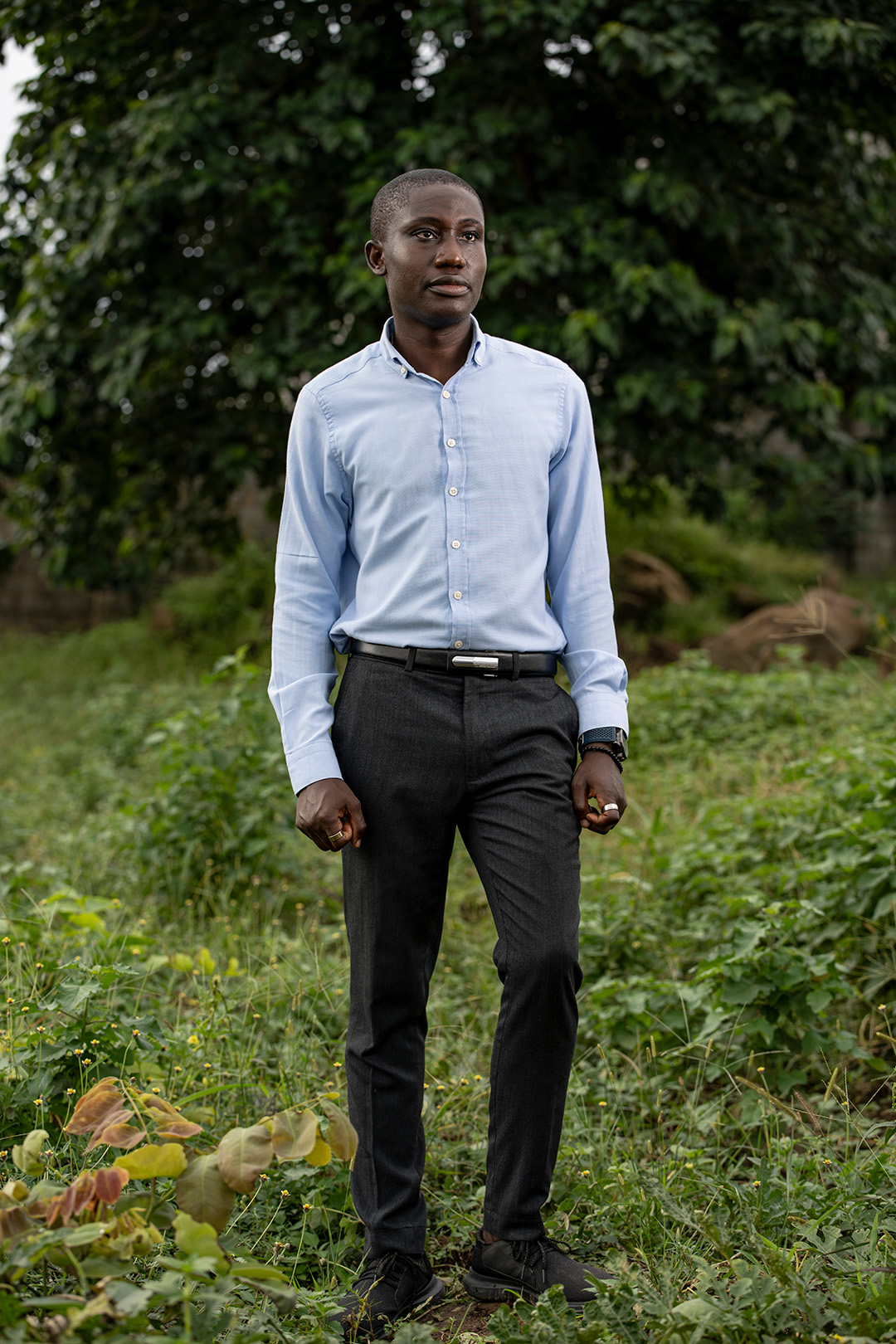 Portrait of Emmanuel Nwachukwe on a foliage background