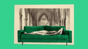 A woman lying on a couch with a church in the background.