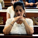 A woman prays at St. John the Baptist Church in Thane, India.