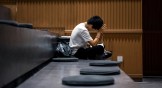 A Chinese student sitting and studying in a classroom