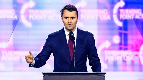 Charlie Kirk speaking on stage at America Fest 2024.