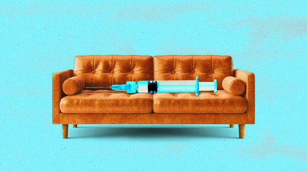 A syringe laying on a couch.