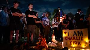 People gather around the memorial space during a Charlie Kirk vigil at Burlington Commons on September 17, 2025 in Burlington, Kentucky.