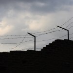 A prison wall with barbed wire