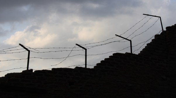 A prison wall with barbed wire