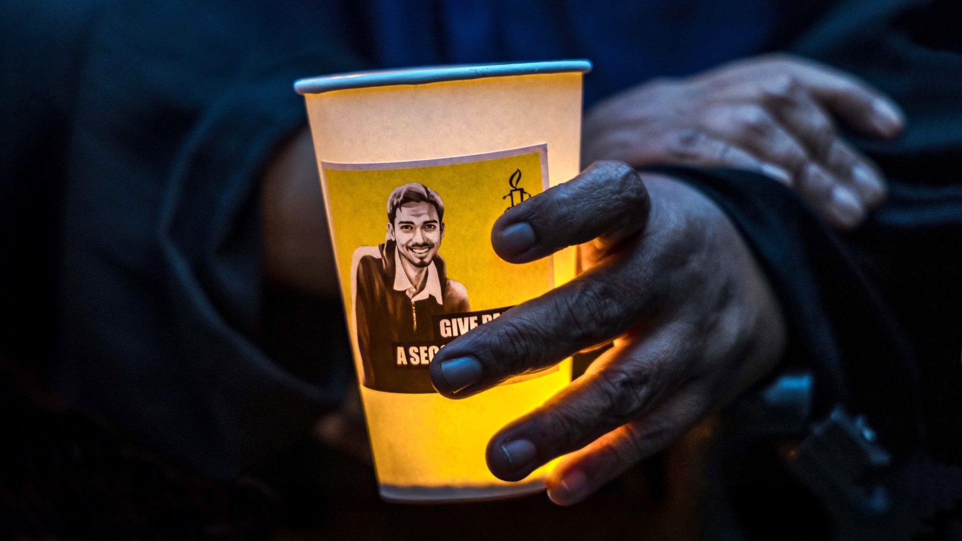 Activists attend a candlelight vigil to protest the impending execution of Pannir Selvam Pranthaman.