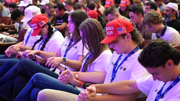 Attendees pray during a Turning Point USA event on September 24, 2025.