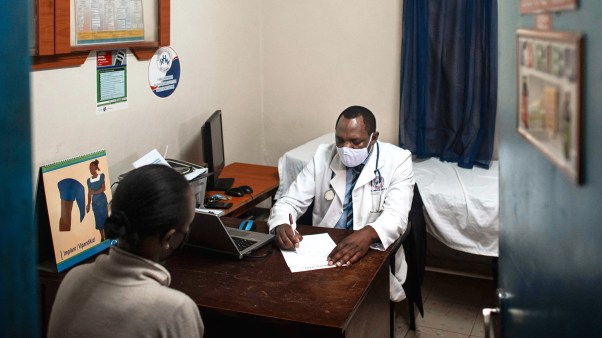 A doctor specializing in reproductive health attends to a patient at his clinic in Kenya on September 16, 2021.