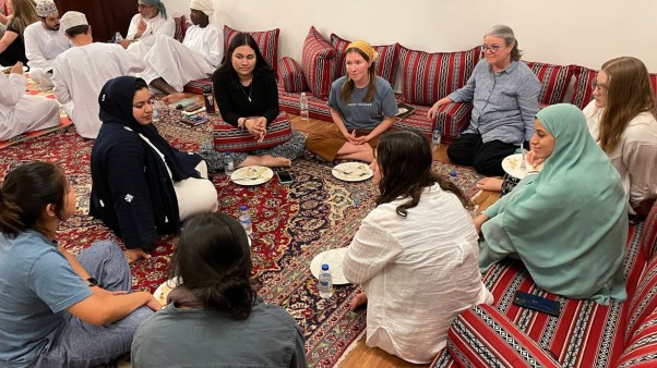 American Christians and local Muslims eating lunch together in Oman.
