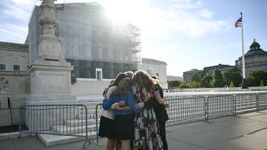 Members of the group "Concerned Women for America" pray outside the US Supreme Court as the Court hears oral arguements in Chiles v. Salazar.