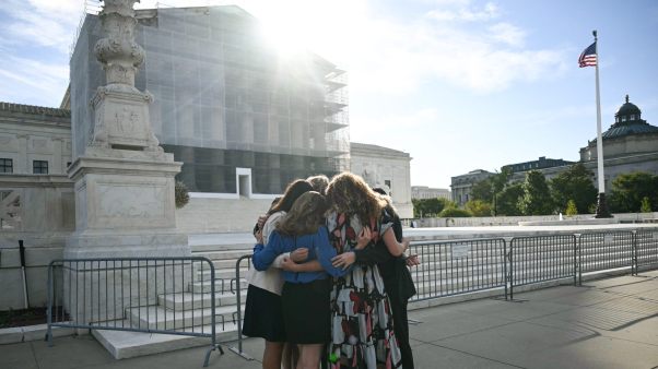 Members of the group "Concerned Women for America" pray outside the US Supreme Court as the Court hears oral arguements in Chiles v. Salazar.