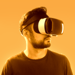 A man looking into virtual reality goggles.