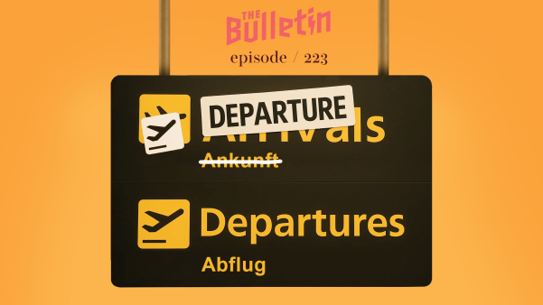 Airport sign in English and German with "Arrivals" crossed out and replaced with "Departure."