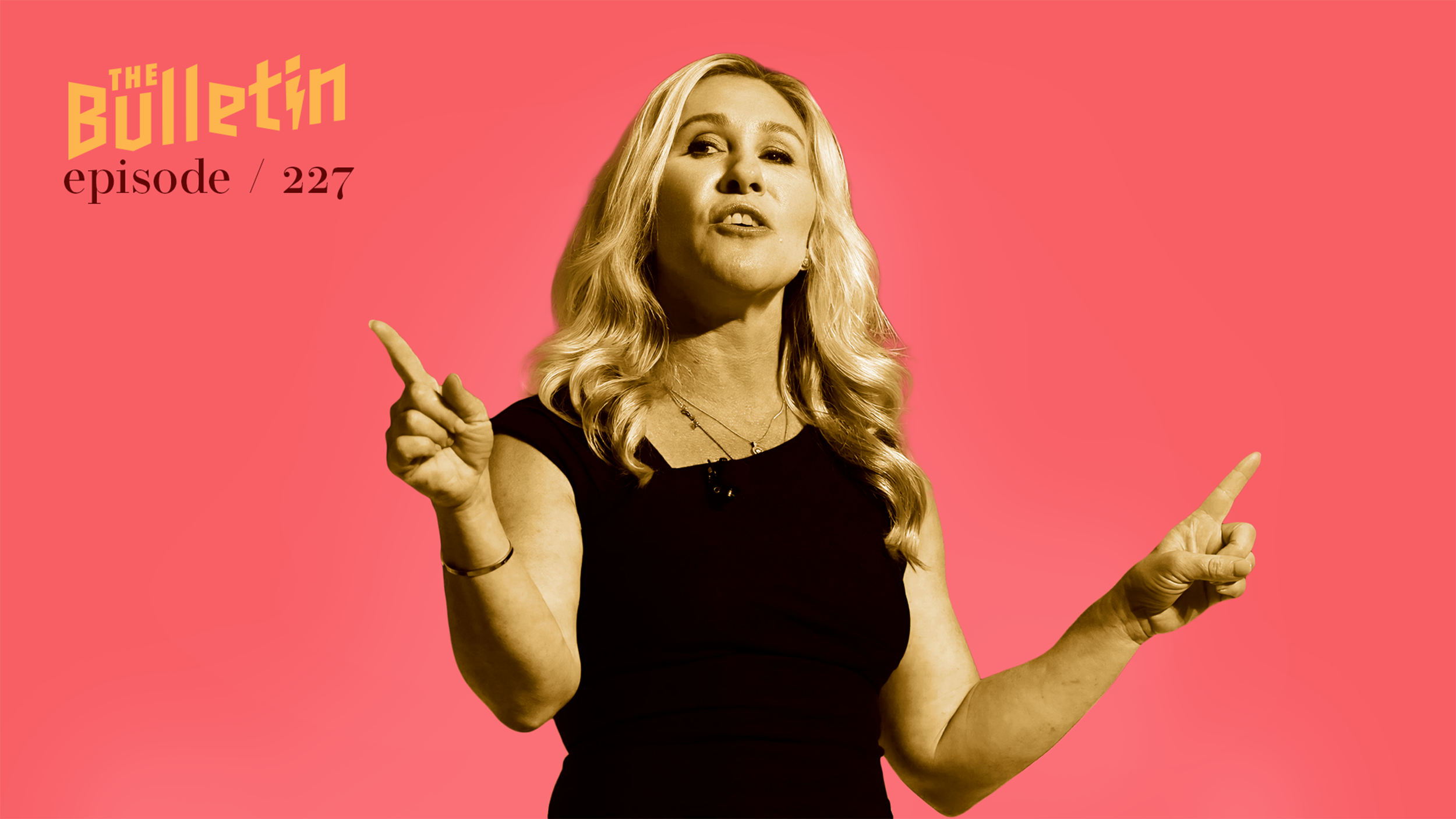 Marjorie Taylor Green giving a speech and pointing with both pointer fingers.