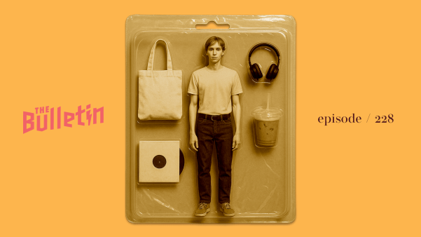 A male doll in a plastic package, along with a tote bag, a record, headphones, and an iced matcha latte.