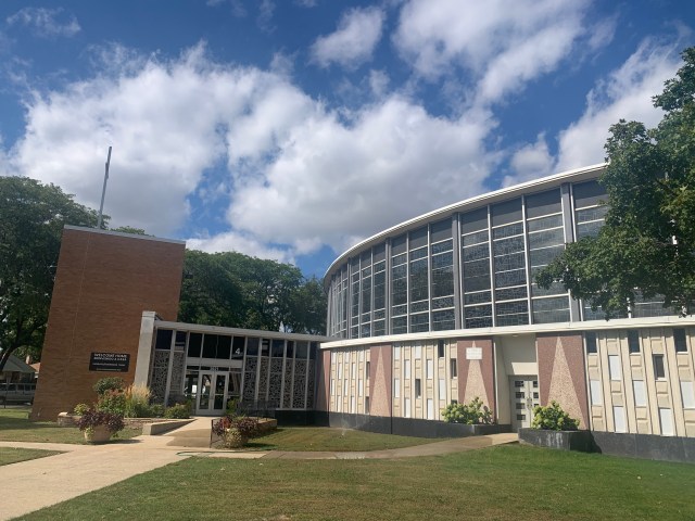 A rounded church building with stained glass widows.