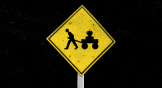 A yellow road sign and a figure pulling a wagon with a robot inside it.