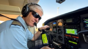 Kevin Rideout makes preflight checks before transporting a team from Hope Springs International in Niger.