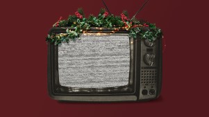 An old TV covered in Christmas decorations.