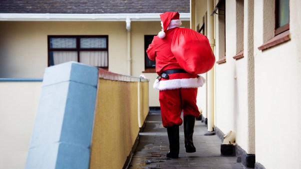 A man wearing a Santa suit.