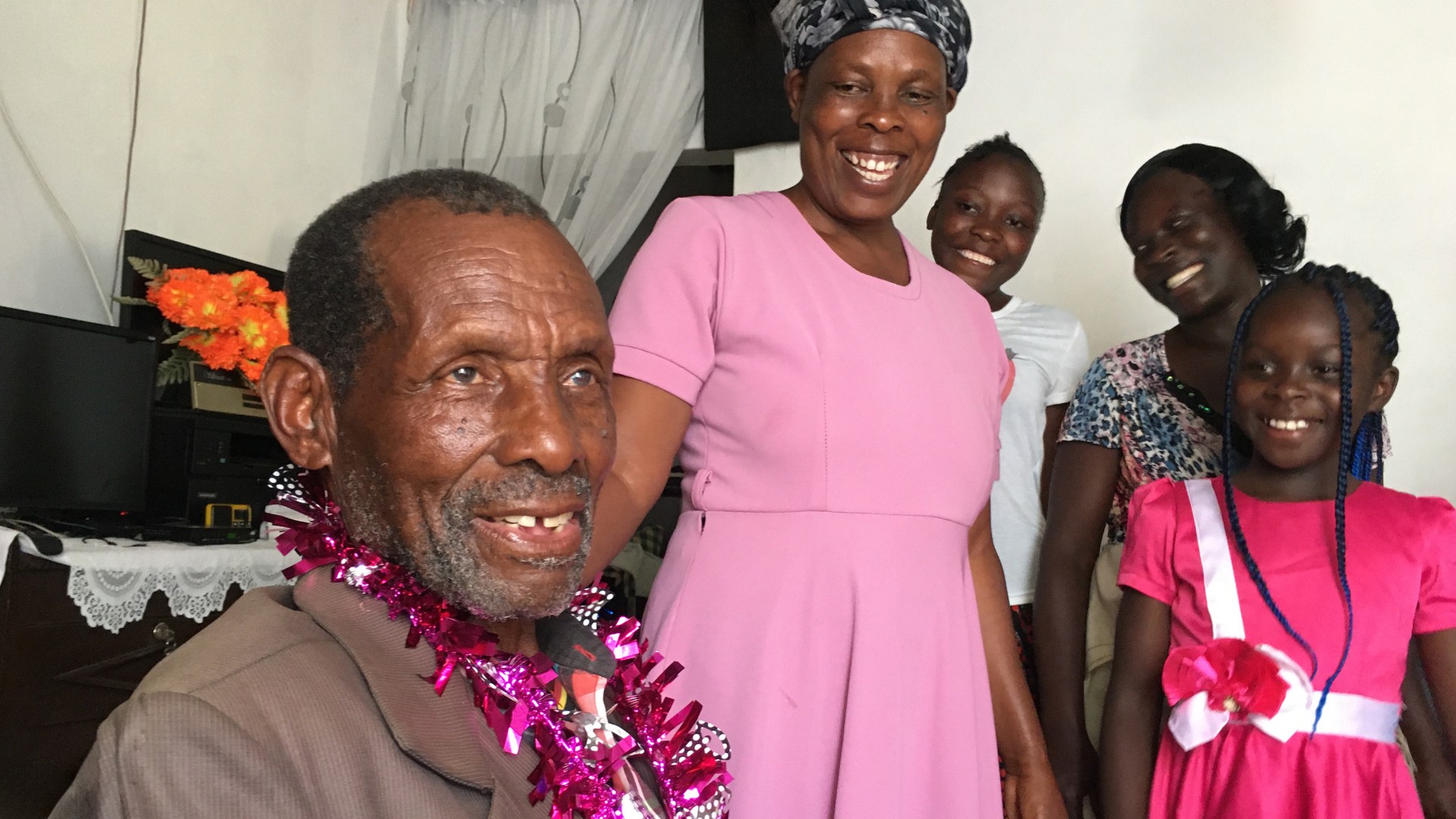 Wafula celebrating his 91st birthday with his daughter and grandchildren in December 2024.
