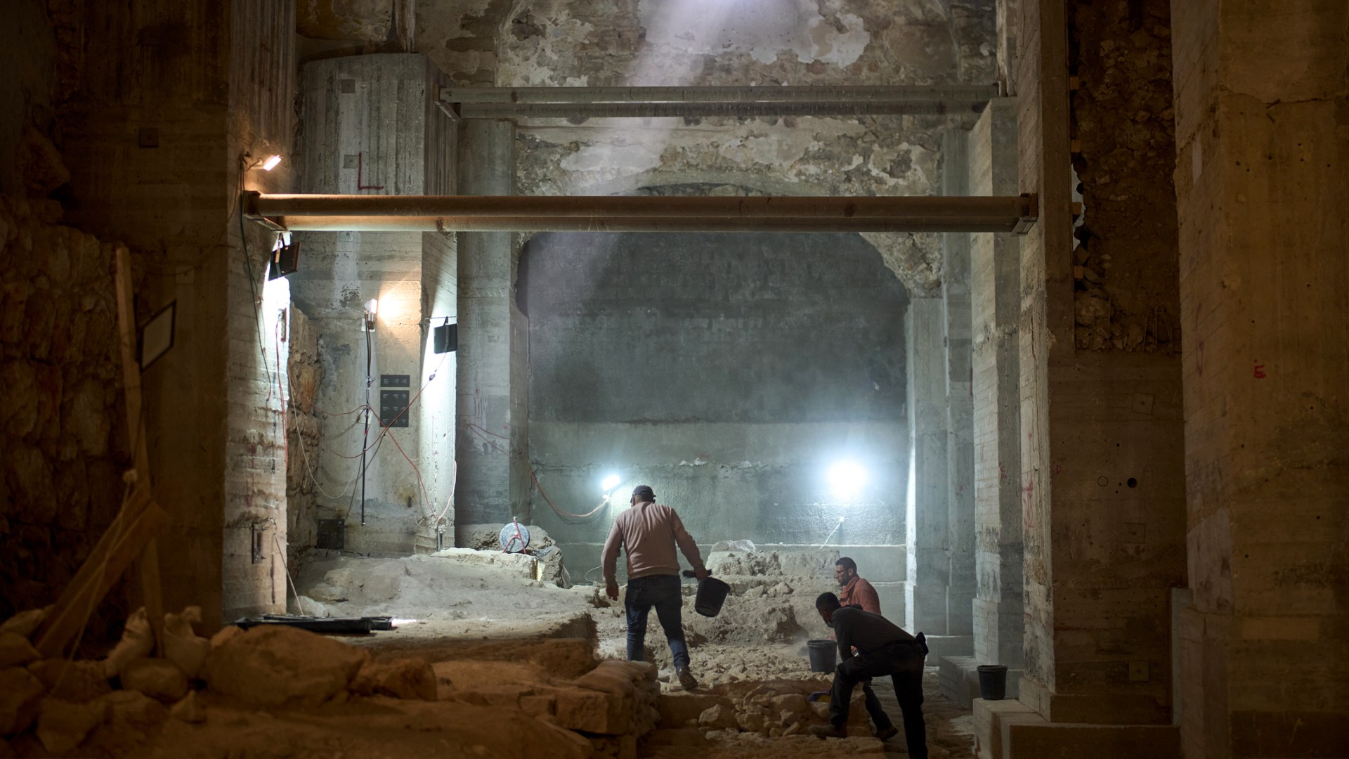 Workers from the Israel Antiquities Authority excavate a section of a city wall from the Hasmonean period in the Old City of Jerusalem.