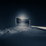 A glowing manger in snow.