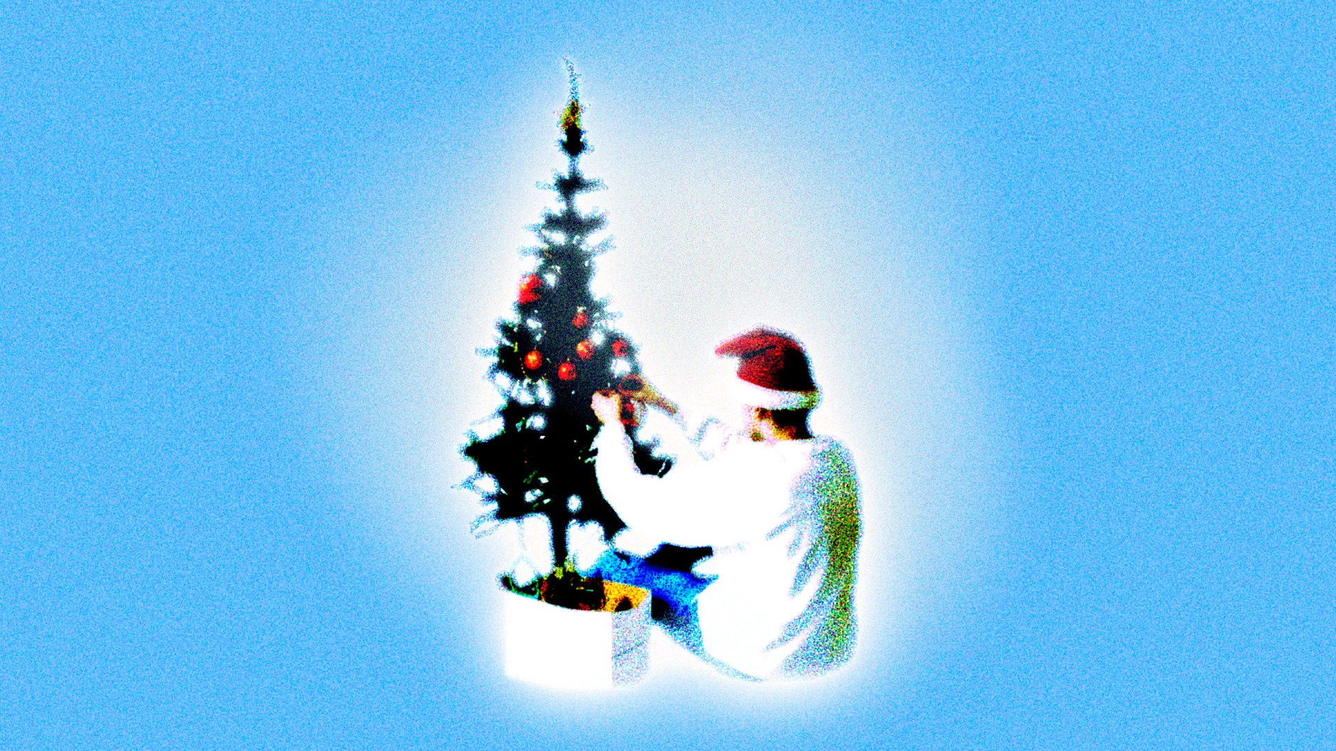 A teenage boy decorating a Christmas tree.