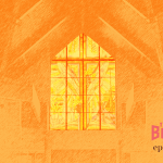 A stained class window from the inside of a church, monochromatic orange.