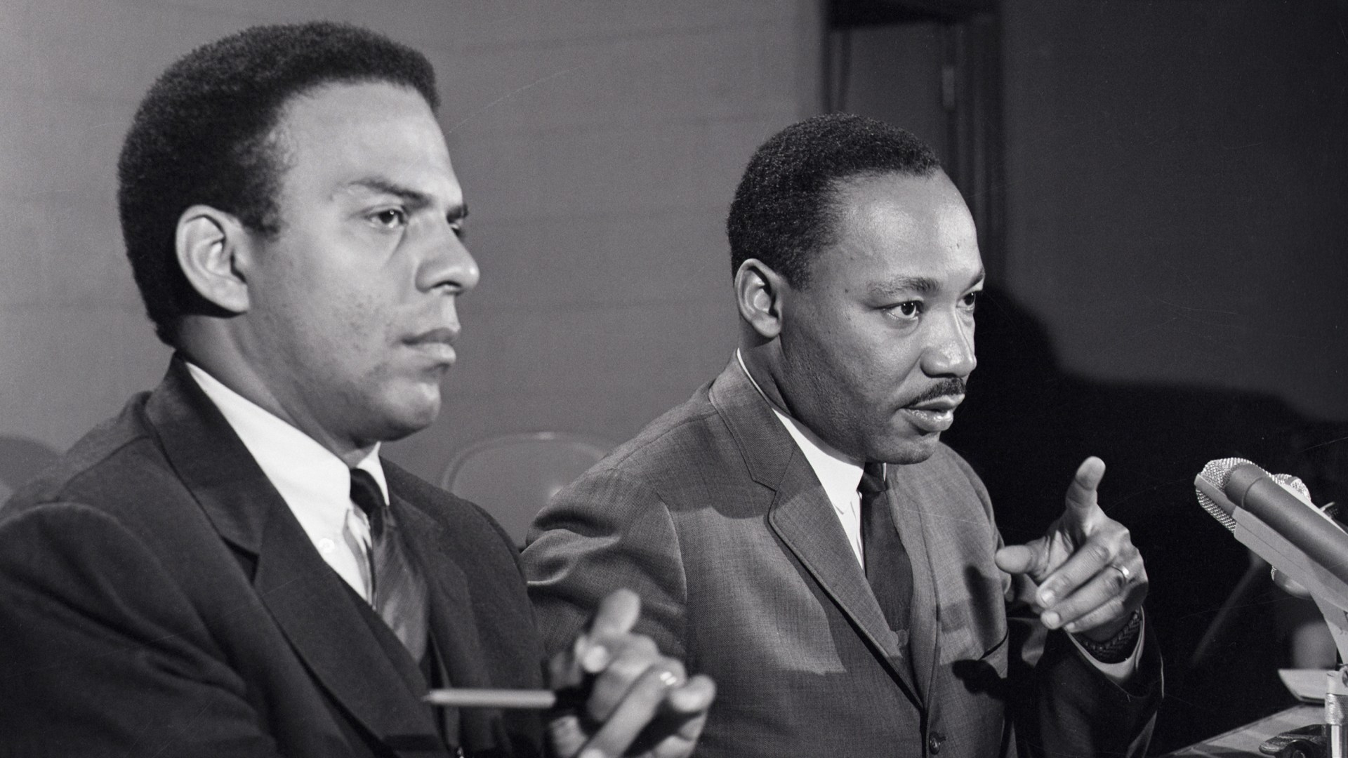 Dr. Martin Luther King Jr. at a press conference accompanied by his aide Reverend Andrew Young.