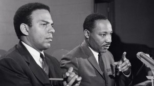 Dr. Martin Luther King Jr. at a press conference accompanied by his aide Reverend Andrew Young.
