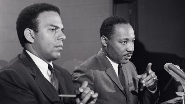 Dr. Martin Luther King Jr. at a press conference accompanied by his aide Reverend Andrew Young.