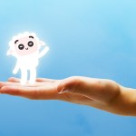 A hand holding the sheep character from Creed's AI app.