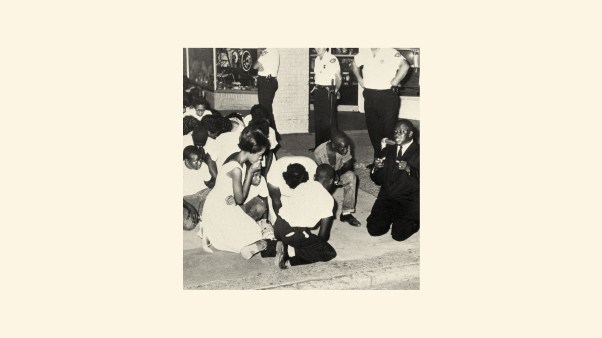 A photo of people praying at a peaceful Civil Rights protest.