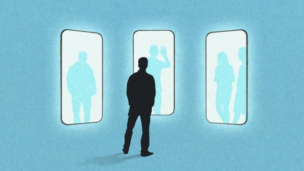 A person standing in front of several giant phones.