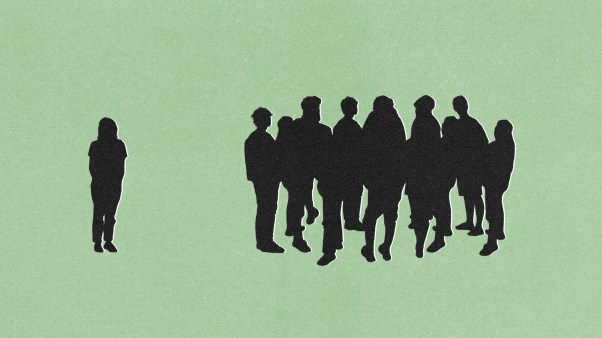 A woman excluded from a group of people talking.